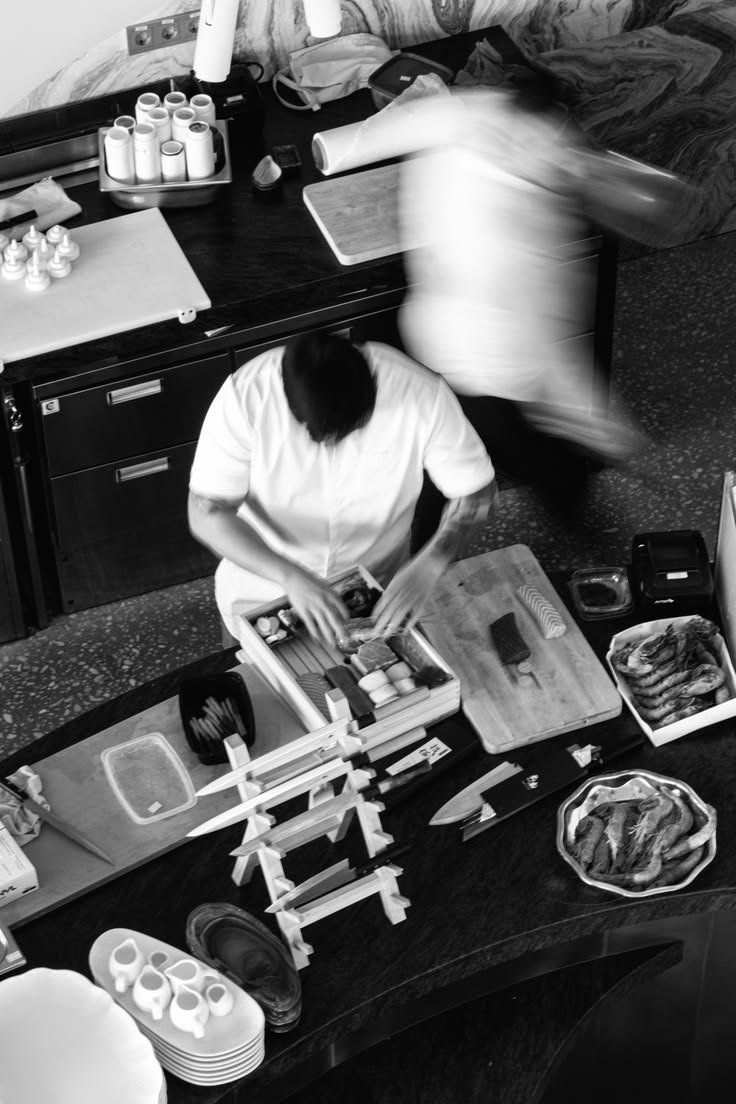 Restaurant team moving through a busy kitchen pass